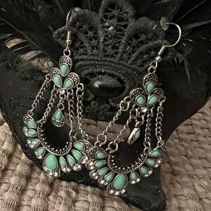 Silver tone hanging earrings with turquoise beads